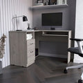 L-shaped desk with a keyboard tray, finished in a smoked oak color; high-quality, sturdy, and durable.