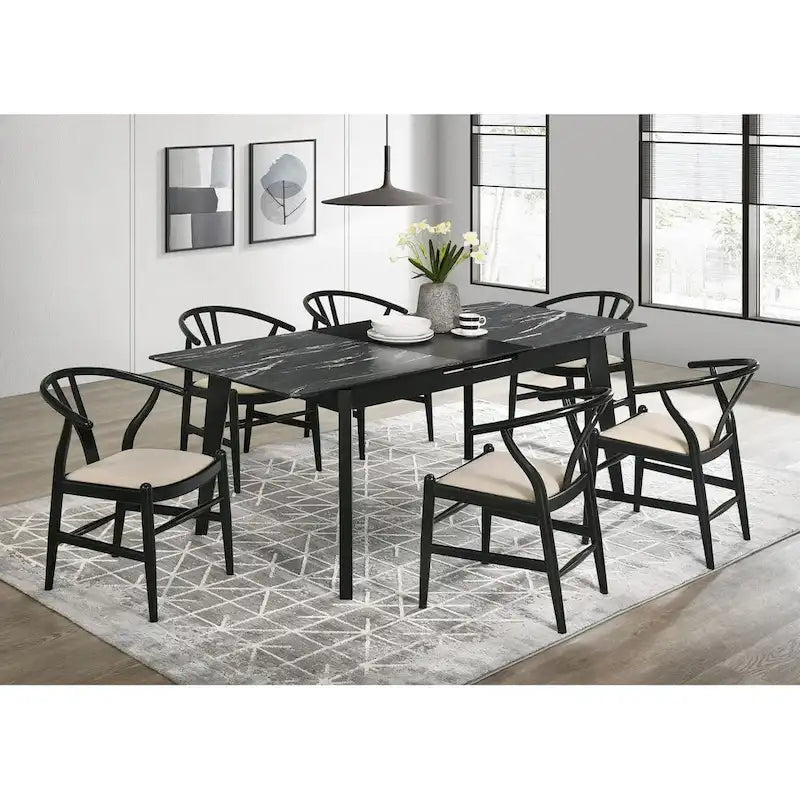 Black dining table with a self-storing extension leaf
